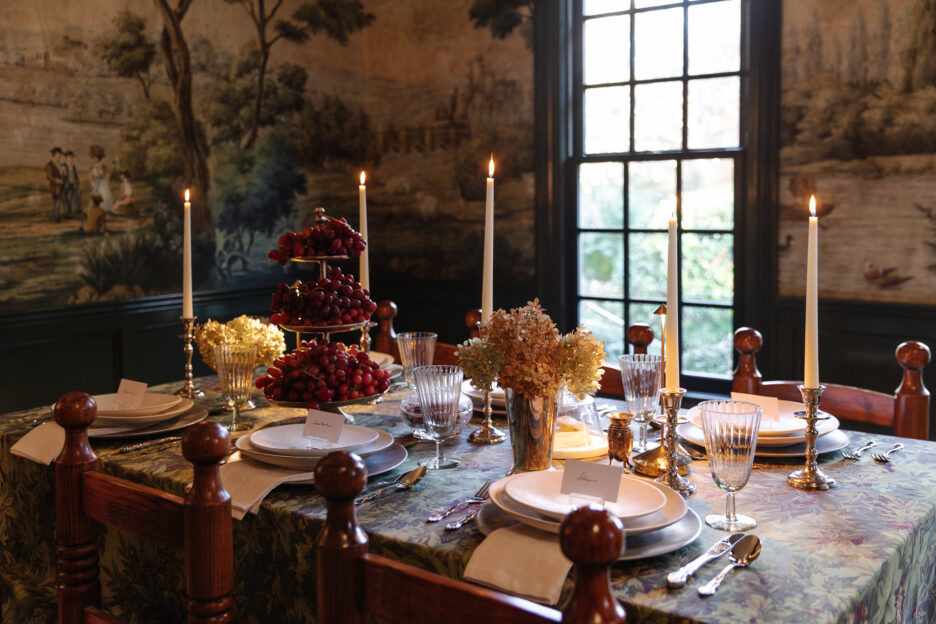 Vintage-inspired dining room table setting with elegant candlelit decor, floral centerpiece, and fine china, perfect for classic home entertaining and interior design inspiration.