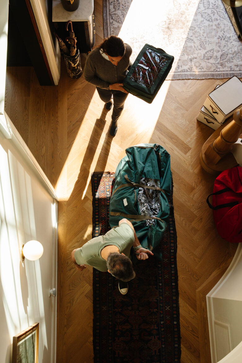 Luggage and packing essentials for travel in a stylish home, showcasing a couple preparing for a trip, with natural light and organized space emphasizing home decor and travel readiness.