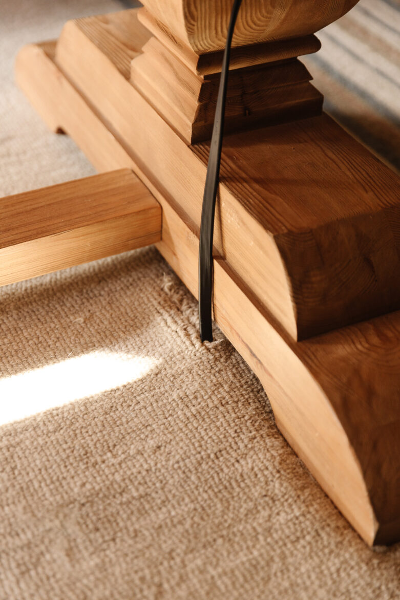 A hole in the rug to allow for a flat power cable line to be hidden