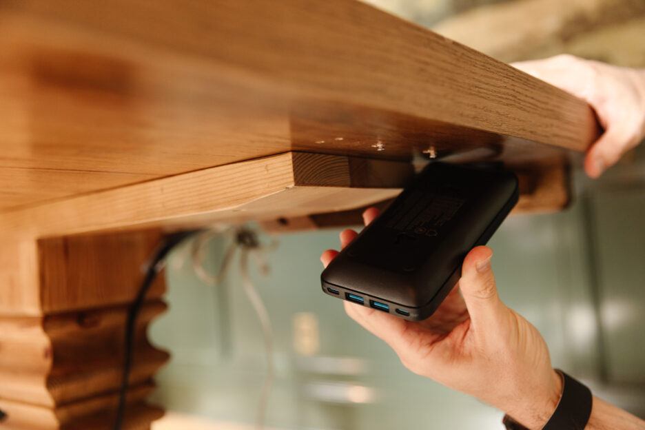 Chris snapping the power strip onto the underside of the desk