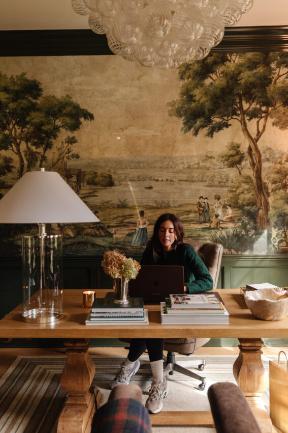Julia working at the desk in the study with no wires or cables in sight