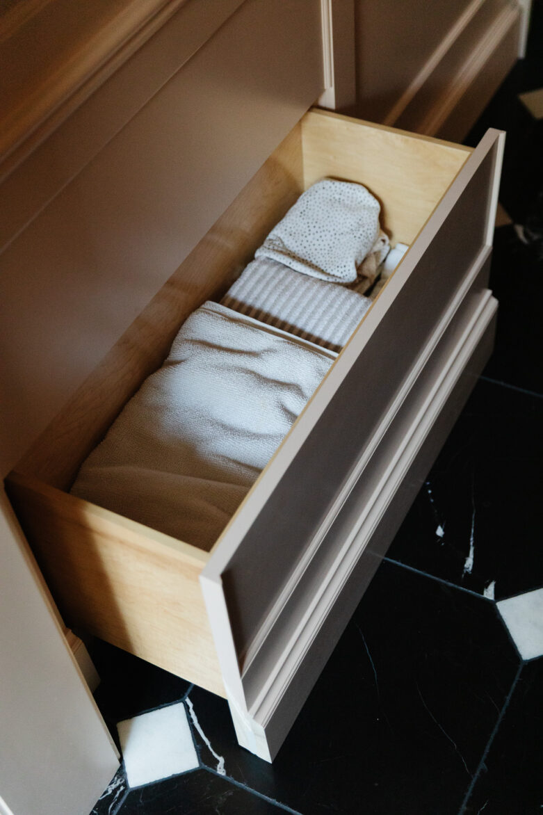 Stacked towels in a wooden dresser drawer