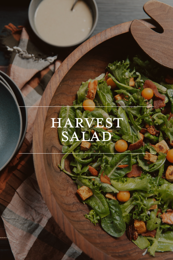 Fresh harvest salad with greens cherry tomatoes bacon croutons and balsamic dressing served in a wooden bowl for healthy eating and meal ideas.