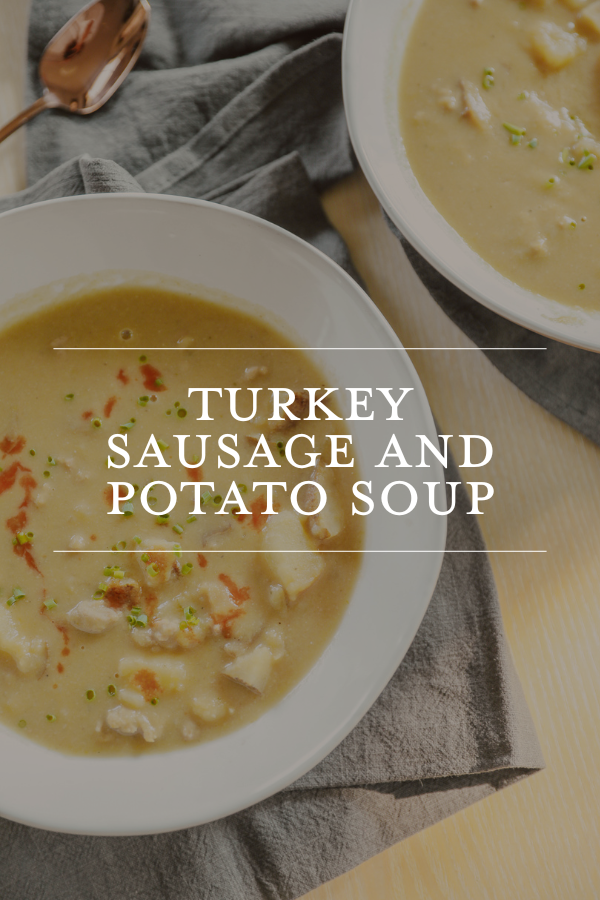 Creamy turkey sausage and potato soup in white bowls, garnished with green herbs, on a wooden table with a gray napkin, showcasing a comforting homemade recipe from Chris Loves Julia.
