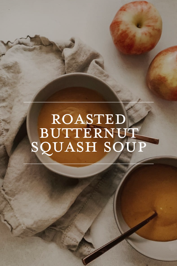 Creamy roasted butternut squash soup served in bowls with fresh apples and a cozy linen cloth, perfect for fall comfort food recipes.