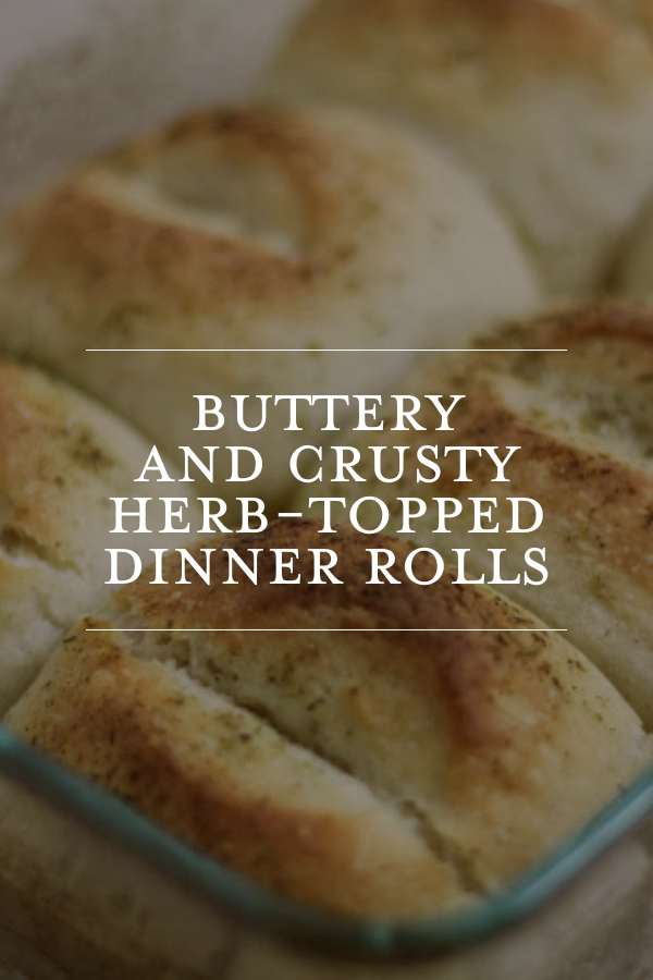 Buttery and crusty herb-topped dinner rolls in a glass baking dish, perfect for holiday meals and family dinners, showcasing homemade bread recipes from Chris Loves Julia.
