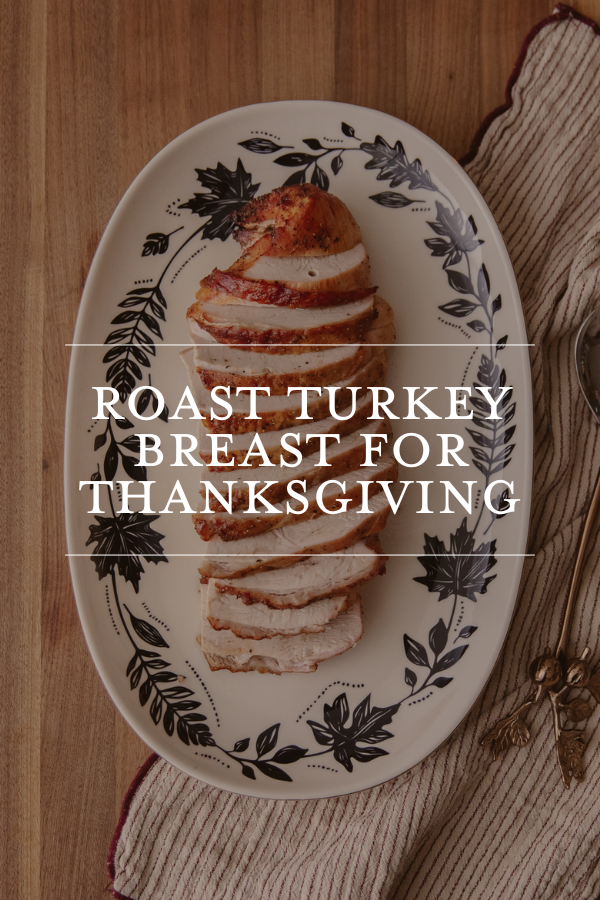 Roast turkey breast for Thanksgiving on decorative serving platter with herbs, ideal for holiday meal preparation and family gatherings. Perfect for a traditional festive dinner.