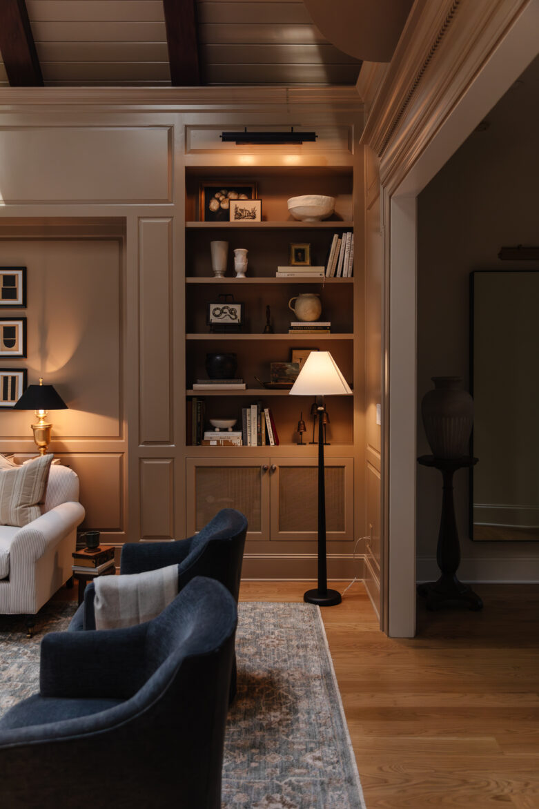 Modern living room with built-in bookshelf, cozy seating, and warm lighting highlighting home decor and interior design elements for a stylish and inviting space.