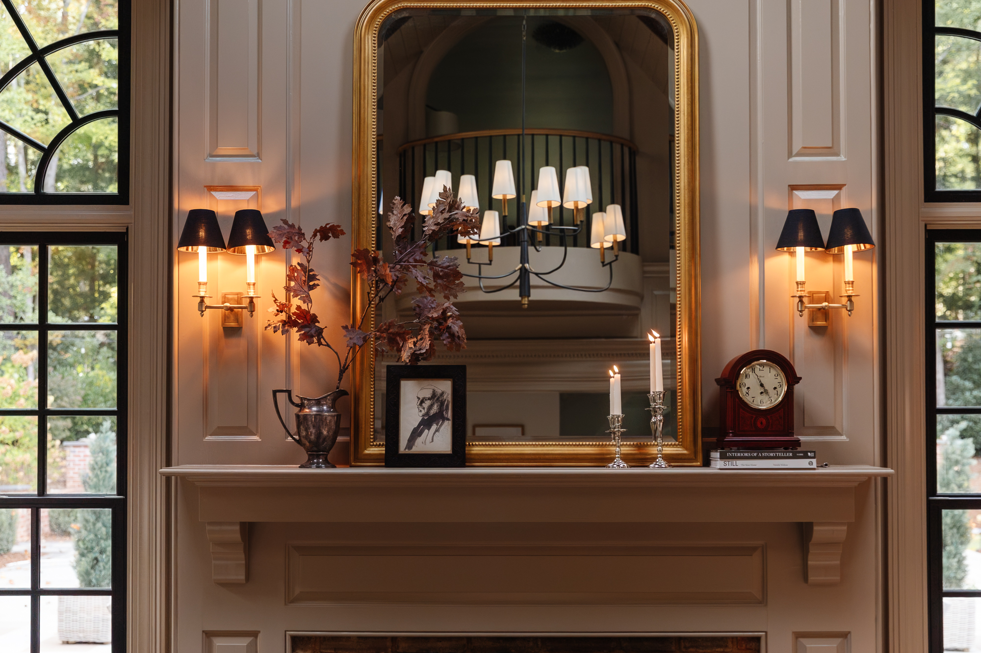 Vintage-inspired fireplace mantel with elegant wall sconces, a large gold-framed mirror, and cozy decor, showcasing timeless interior design and lighting ideas for a sophisticated living space.