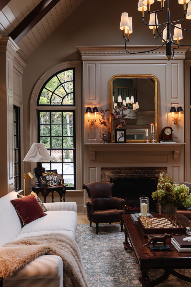 Cozy living room with a fireplace, elegant decor, and vintage accents inside a beautifully styled home.
