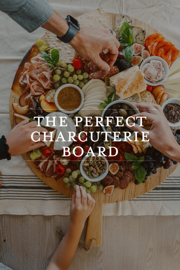 A beautifully arranged charcuterie board with cheeses, cured meats, fresh fruits, nuts, and toppings, designed for entertaining tips from Chris Loves Julia. This image highlights the art of creating the perfect charcuterie platter for parties or casual get-togethers.