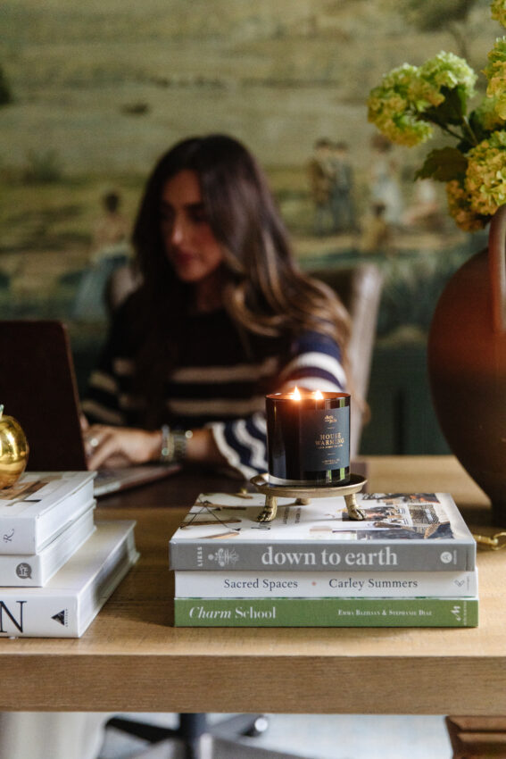 Julia at a desk with a lit candle