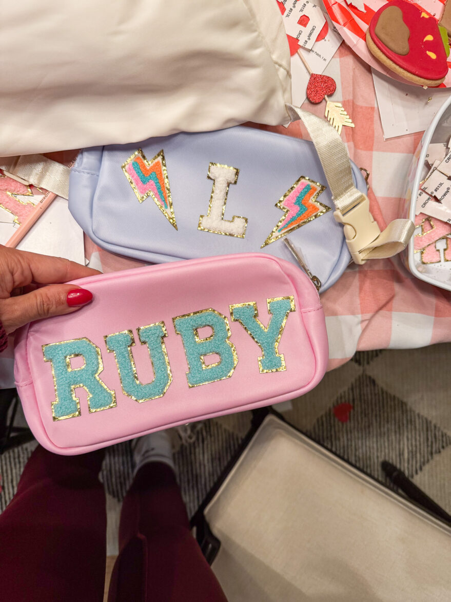 Bright pink pencil case with "RUBY" in glittery blue letters, perfect for storing school supplies.