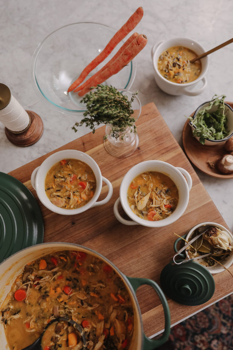 Delicious homemade soup served in white bowls, garnished with fresh herbs, perfect for a comforting meal.