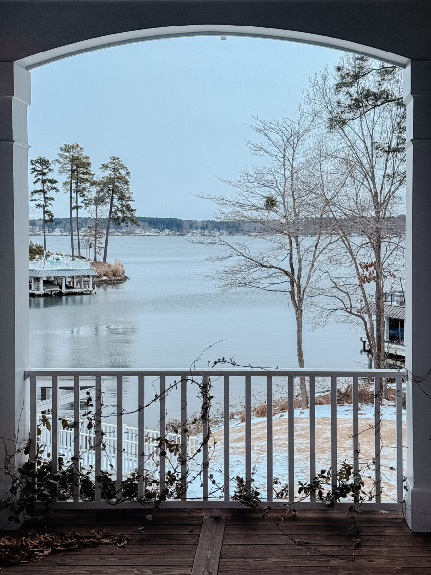 Beautiful winter scene overlooking a lake with bare trees and calm water.