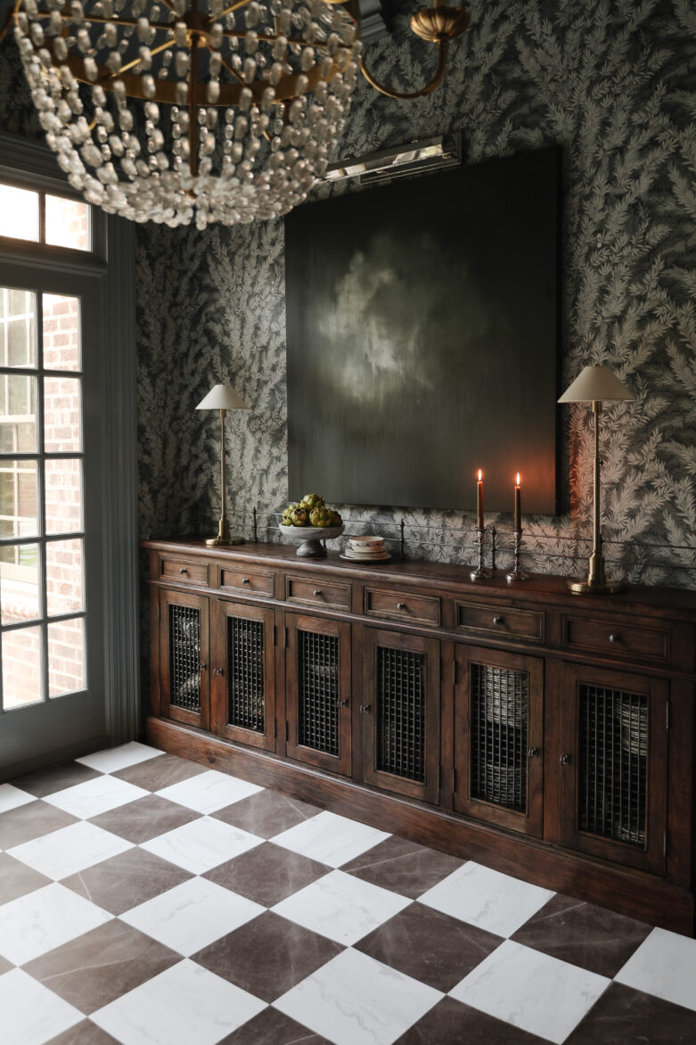 A vintage wooden sideboard with decorative items next to a bronze & white marble-look peel-and-stick floor.