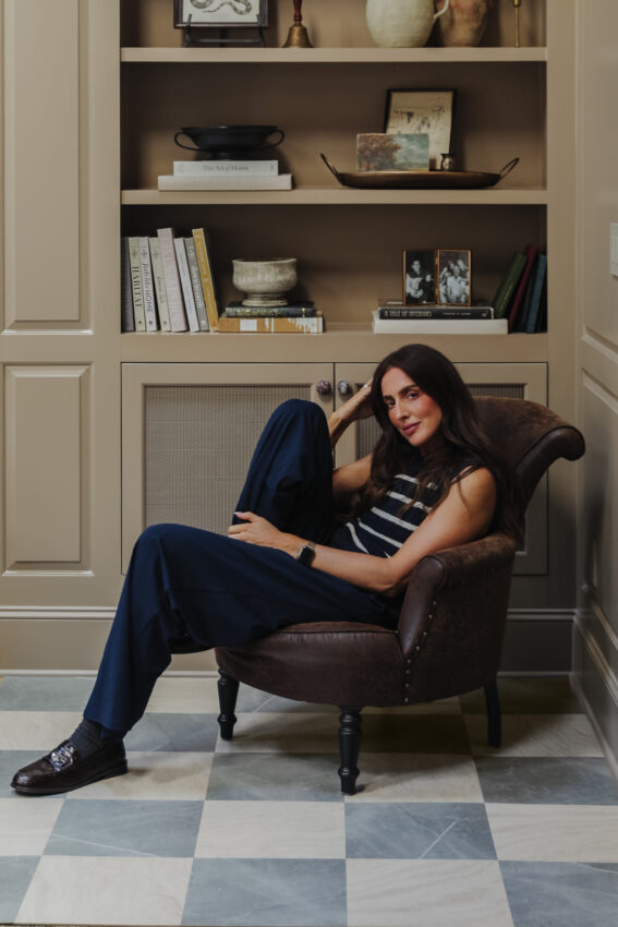 Slate & Beige Peel-and-Stick Tiles in a Living room with Julia sitting in front of a bookcase