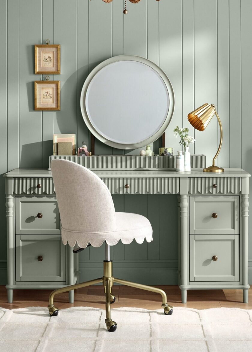 Beautiful mint green vanity with a round mirror, gold accents, and a plush upholstered chair, perfect for a stylish and functional bedroom or dressing area.