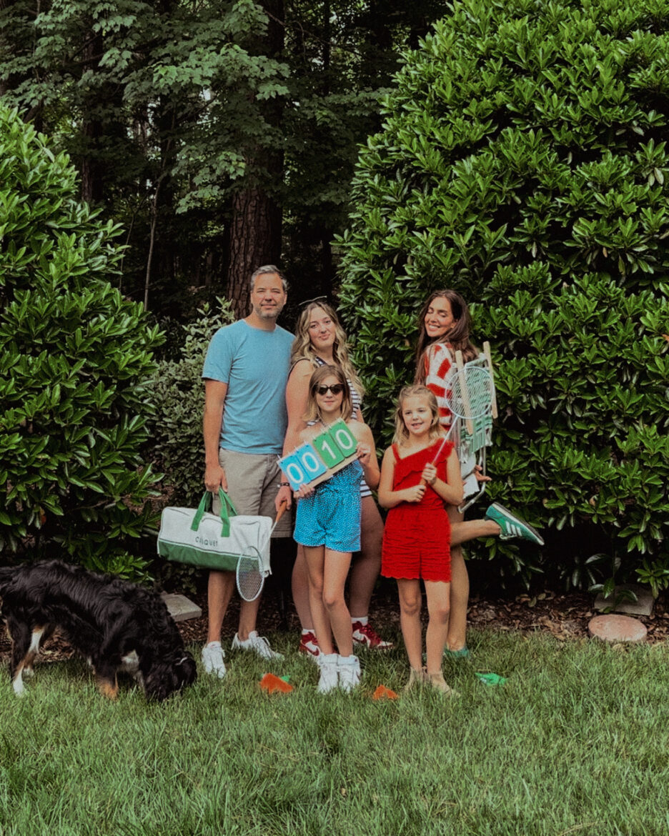 Chris and the Marcum family in the backyard holding lawn games