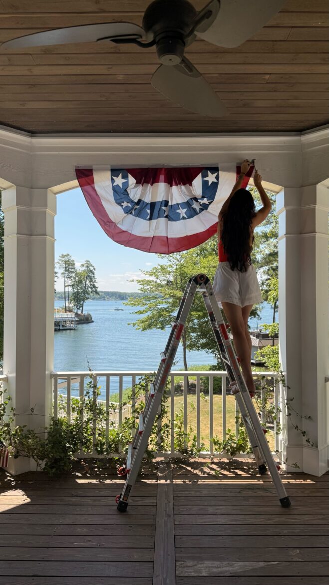 Julia hanging flags at Merrimore for 4th of July