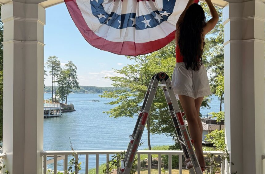 Julia hanging flags at Merrimore for 4th of July