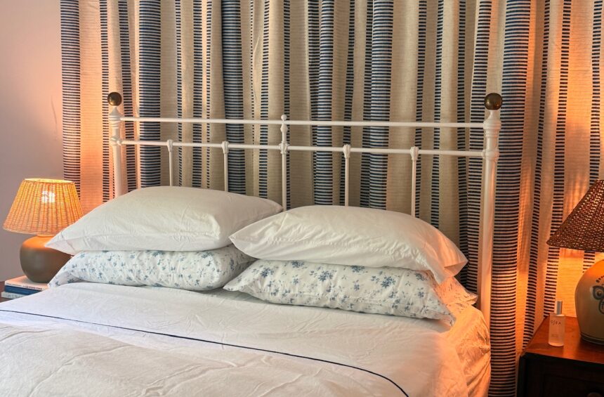 Guest room with cozy lamps, pillow mist, fluffy duvets