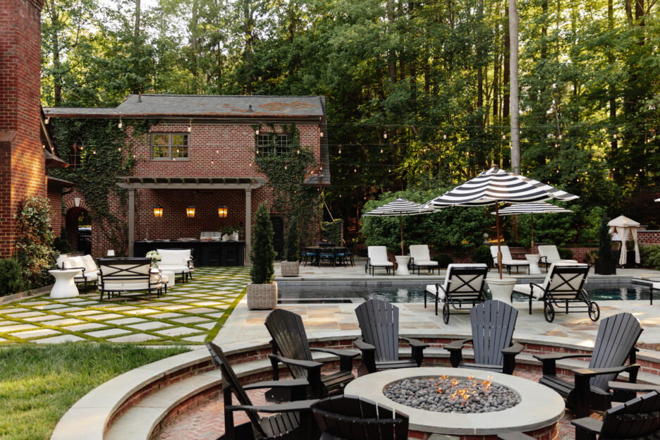 Beautiful sunken fire pit behind a red brick traditional home